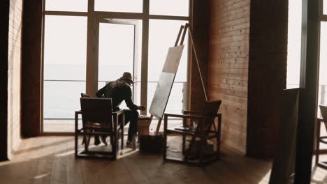 artist painting by the sea