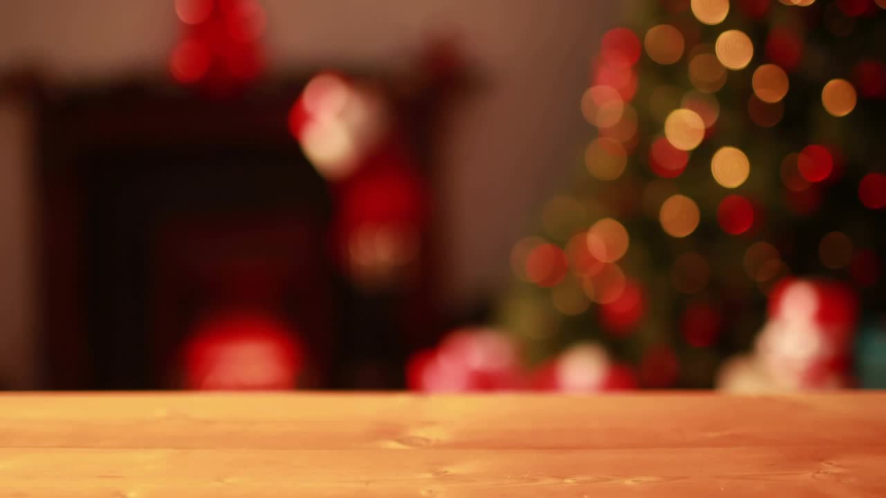 After one-second golden specks emerging above wooden table swirling into veil forming festive glow