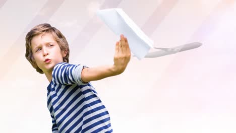 animation of happy caucasian boy playing with paper plane over silhouette of plane