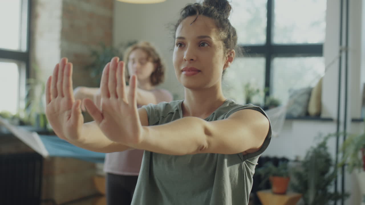 Woman Flexing Wrists on Yoga Class