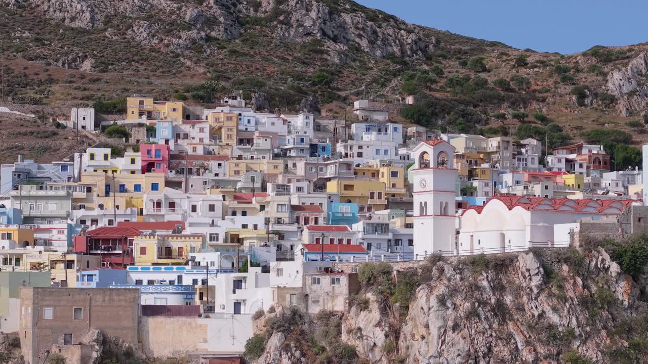 Revealing drone view over Menetes Village, Karpathos Island, showing its vivid architecture and breathtaking Mediterranean scenery
