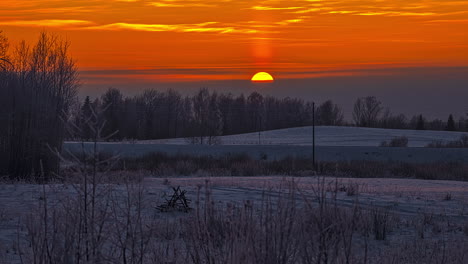 beautiful orange sunset timelapse background, on snowy countryside meadow