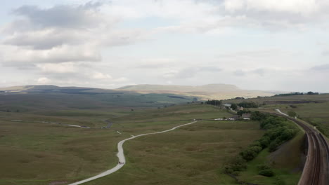 aerial shot revealing ribblehead viaduct in the yorkshire dales national park on a summer’s day