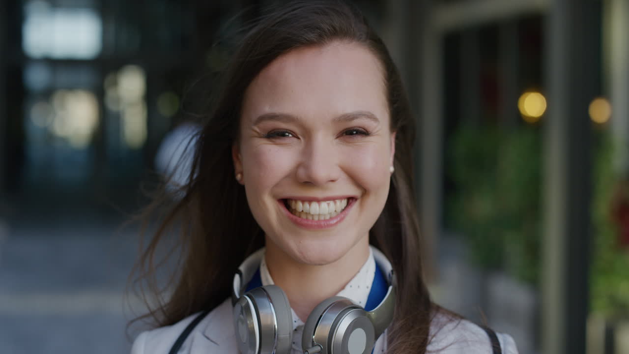 portrait young beautiful business woman smiling cheerful enjoying succesful career lifestyle in city wind blowing hair slow motion