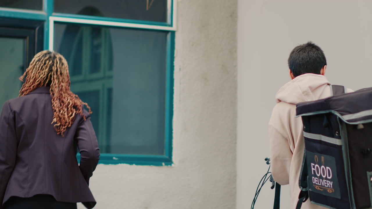 Woman paying for food delivery with credit card