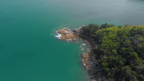 flight over sea bay with rocks in brazil