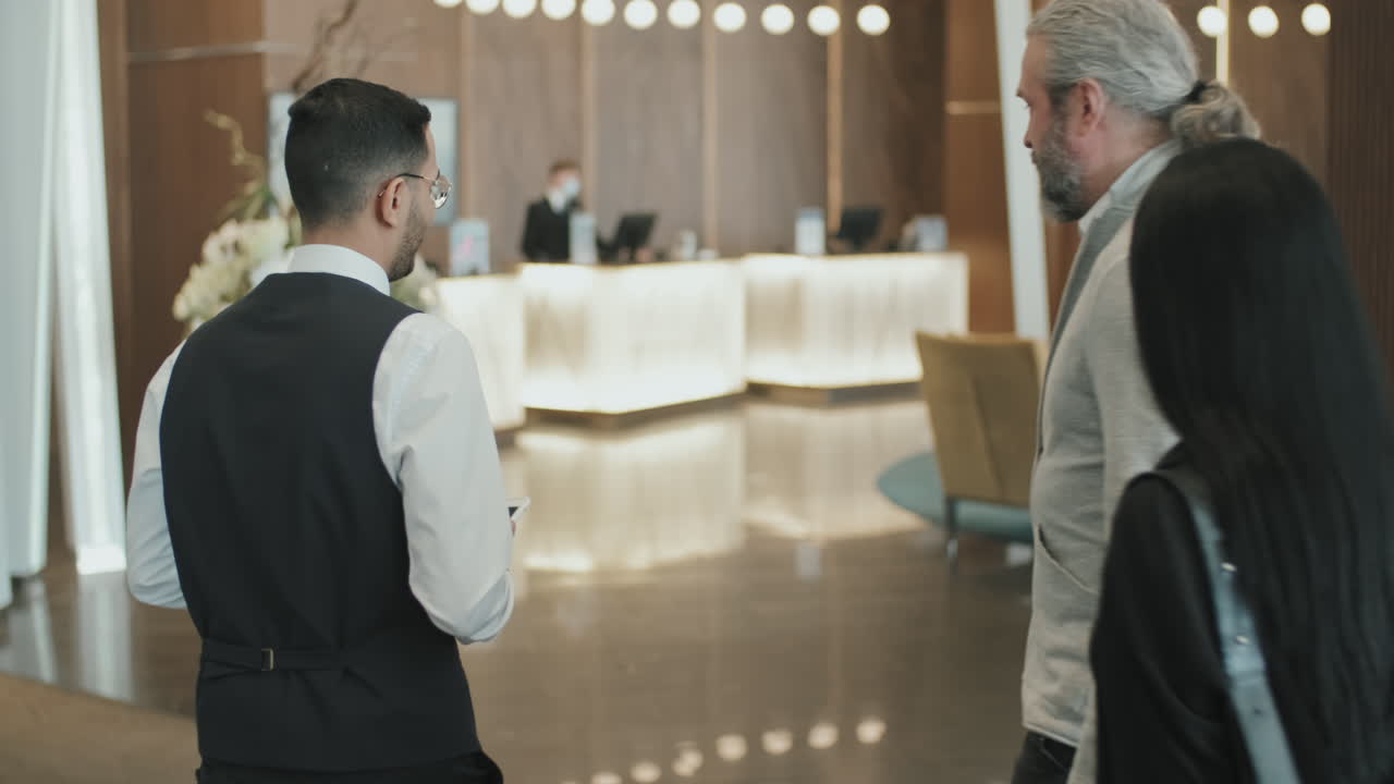 Male Concierge Welcoming Customers in Hotel