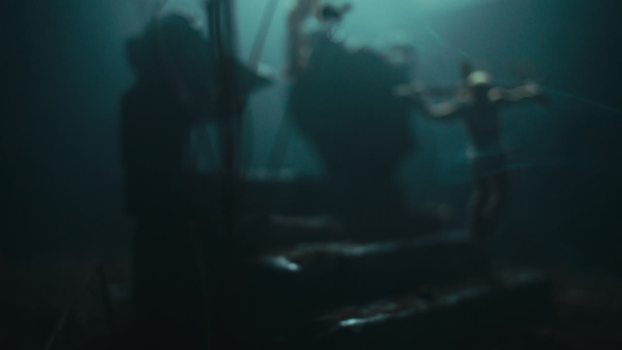 Miniature mummified dolls hanging on the gallows at night