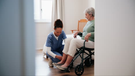 nurse assisting elderly woman in wheelchair