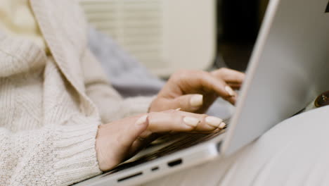 Close-up-of-an-unrecognizable-woman-working-on-laptop-computer-outdoors