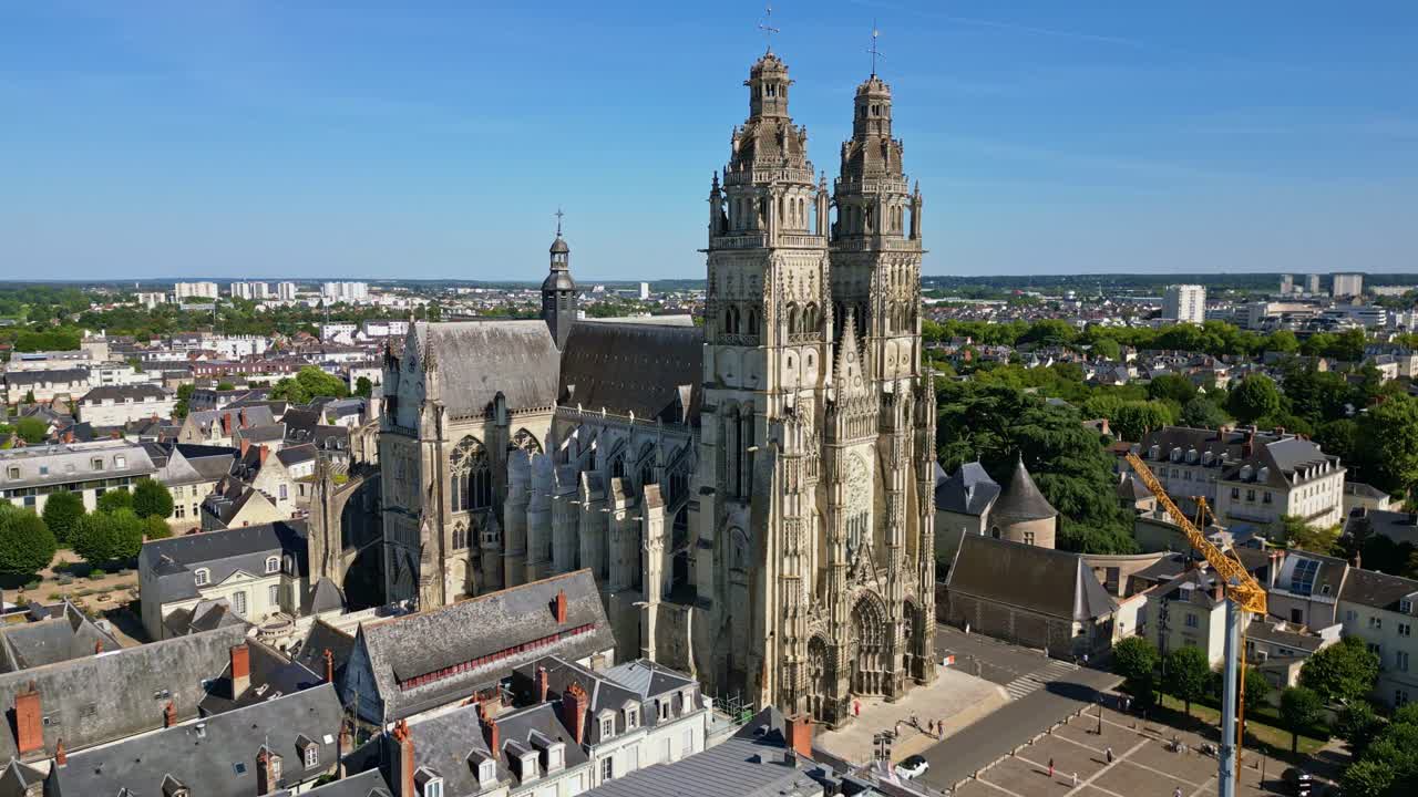 Amazing Saint-Gatien Cathedral in Tours, gothic architecture and surrounding cityscape on sunny day, France. Aerial drone sideways