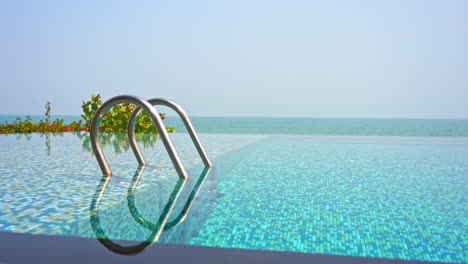 an infinity-edge swimming pool seems to stretch out to connect the with ocean horizon in the distance