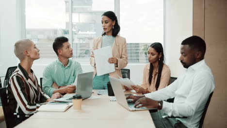 Diverse-group-of-businesspeople-talking-during