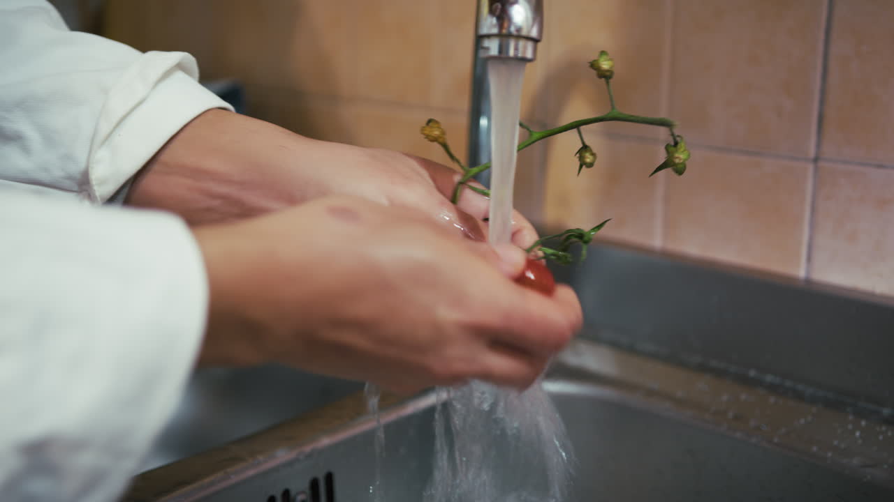 Hands Of A Young Man Chef Wash Red Tomatoes Under Water
