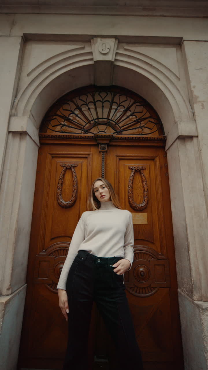 Woman in front of an Ornate Wooden Door