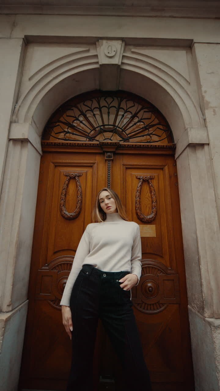 Woman in front of an Ornate Wooden Door