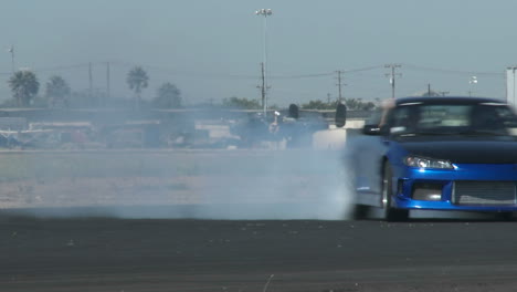 a blue car glides through a drifting course at camarillo airport in camarillo california