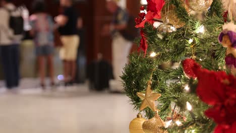 decorated christmas tree with people in background