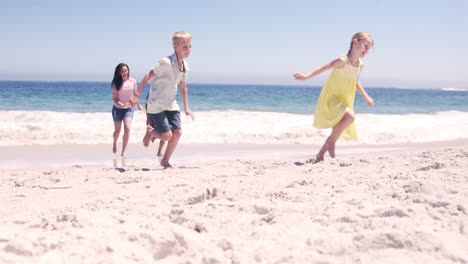 family running on the beach