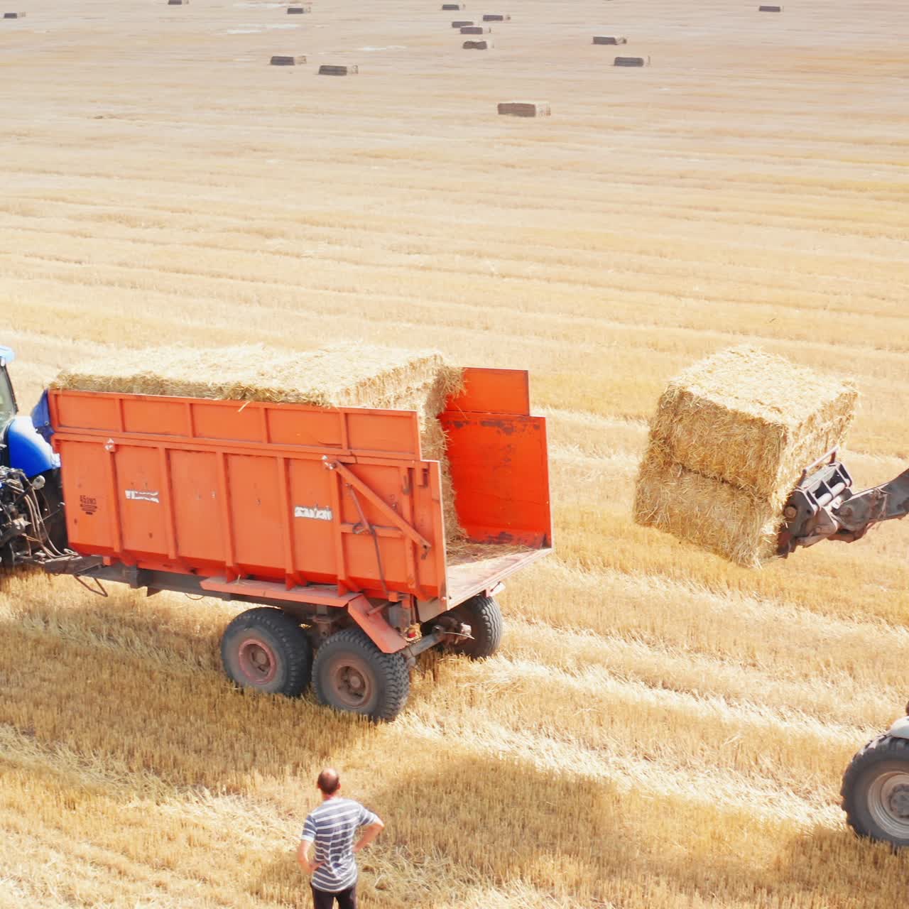 Aerial view of tractor working in the field. Agricultural summer farming field