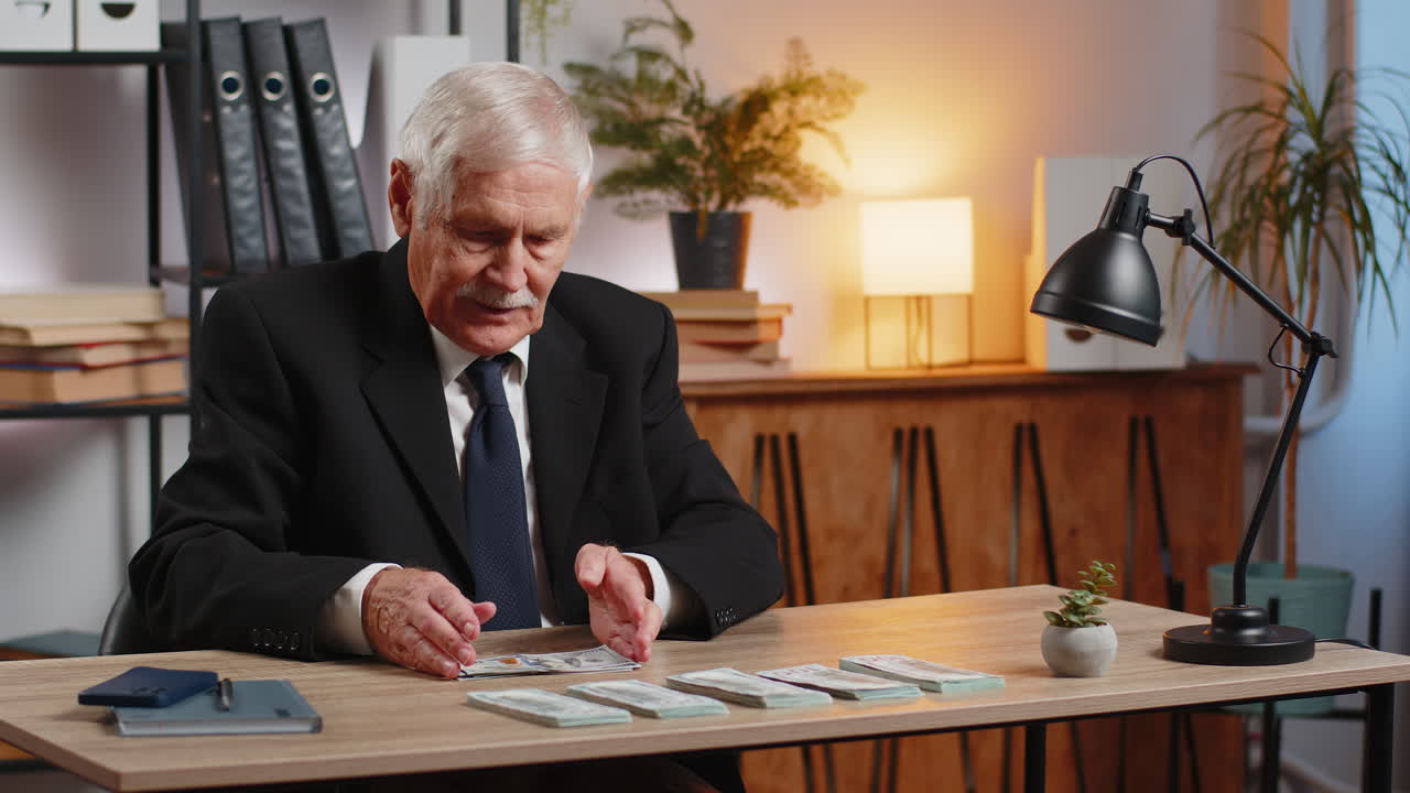 Rich caucasian senior businessman counting money cash calculate earnings income profit at home