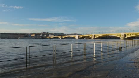 wide shot of the flooding danube river and margaret bridge in the background at budapest, hungary - december 2023