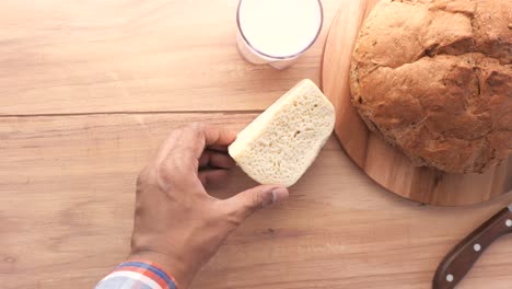 breakfast table with bread, cheese, milk, and nuts