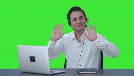 Happy-Indian-call-center-employee-waving-hello-Green-screen