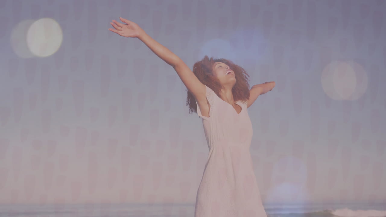 Stretching arms joyfully by ocean, woman in white dress feeling free