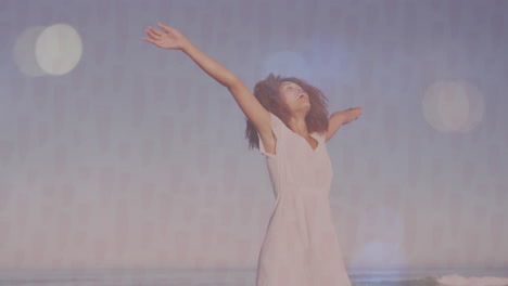 stretching arms joyfully by ocean, woman in white dress feeling free