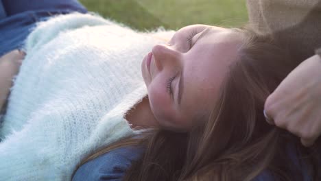 woman lying on someone's lap