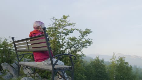 woman relaxing on a mountaintop bench