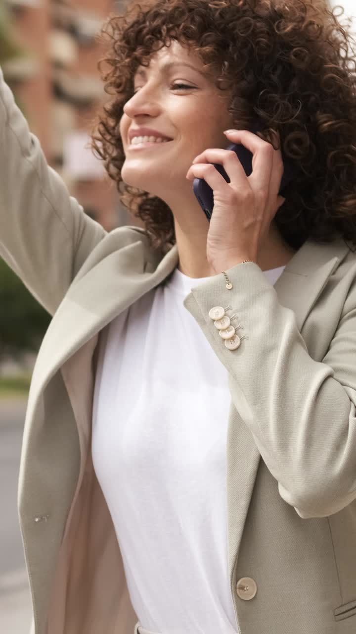 Businesswoman using smartphone on city street. Vertical
