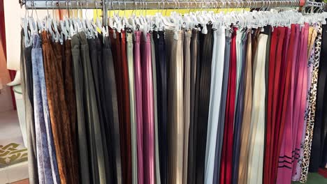 colorful long skirts hanging on a rack in a clothing store