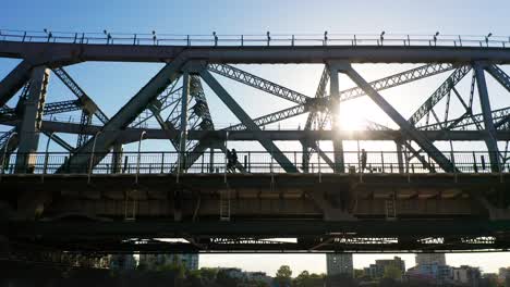 two runners and a walker on a large bridge 'story bridge' in brisbane australia