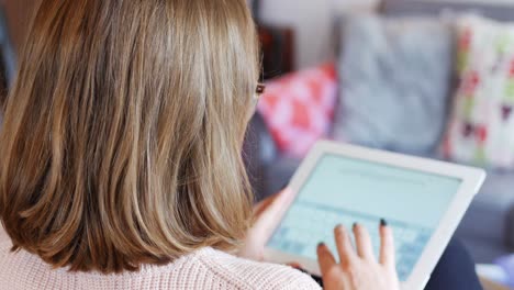 beautiful woman using digital tablet in living room