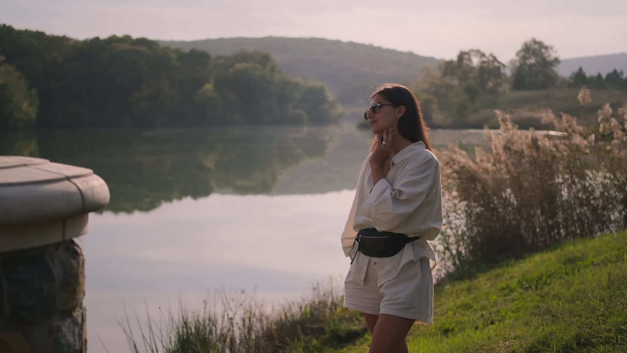 Woman enjoying a sunny day by the lake