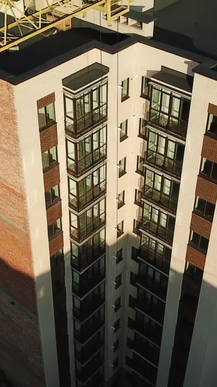 Construction site with tower crane. Construction site with working crane on sky and house district Vertical video