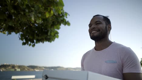 smiling man holding pizza boxes