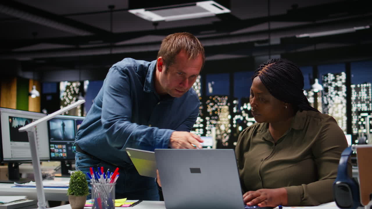 Multiethnic budgeting team reviewing numbers and sales on computer