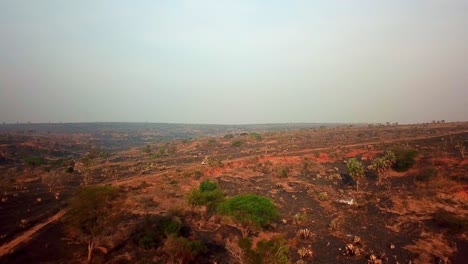 a single utility vehicle driving on barren hill in african wild in kenya, east africa. -  drone tracking shot