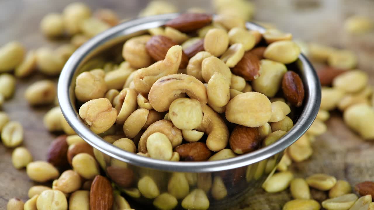 Frutta secca appena tostata su un piatto rotante (loop continuo)