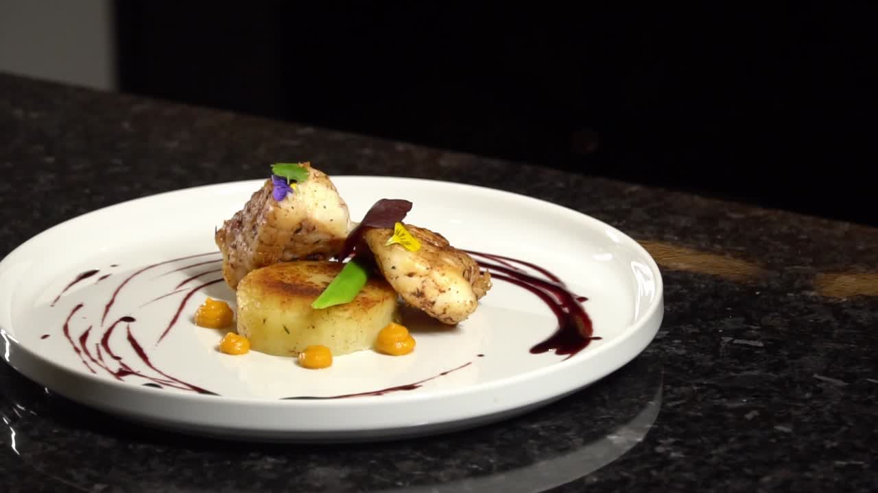 pescado presentado artísticamente en un plato decorado