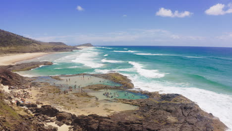 stunning coastal scene with rock pools and people