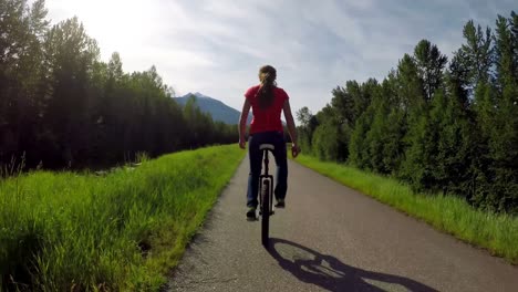 Woman-riding-unicycle-on-the-road-4k