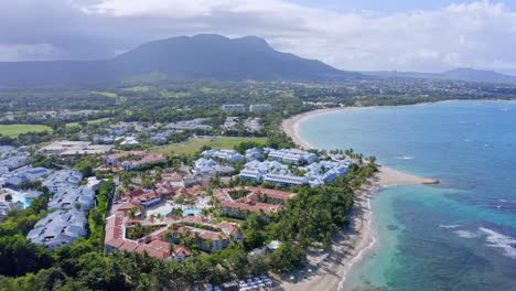 aerial view of coastline of playa dorada beach resort exclusive complex with mountain landscape in background