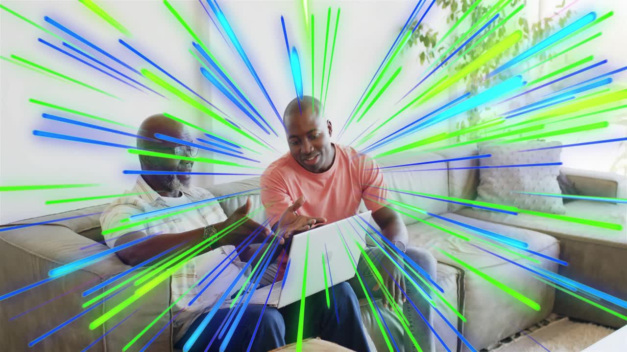 Salmon-shirt man pointing at laptop, other tapping, tech-demo, radial graphic expanding over screen