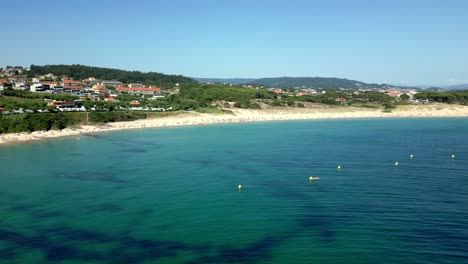 aerial drone footage of crowded shoreline and enchanting forest resort