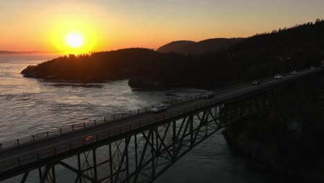 Wide-orbiting-aerial-shot-of-cars-commuting-to-Whidbey-Island-across-the-local-steel-bridge