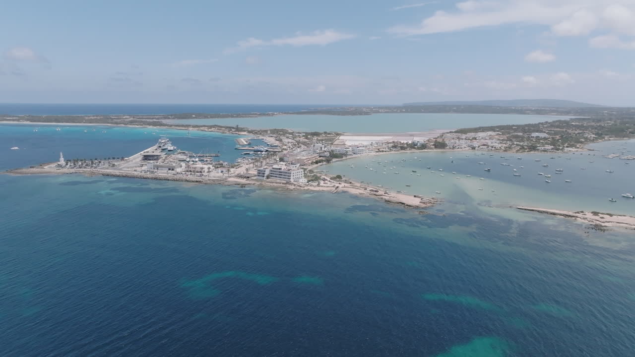Aerial view of a coastal landscape with boats and buildings